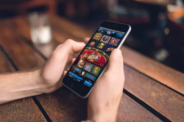 TAS71 App — Fast, responsive, and optimized for all devices A cheerful woman in traditional clothing using her smartphone during a festive moment, showing how easily the TAS71 app fits into everyday life.