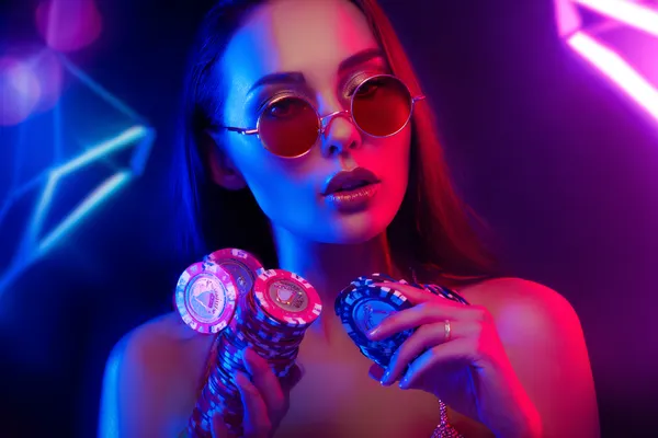 A glamorous woman holding casino chips in a neon-lit environment, representing the premium online casino atmosphere of TAS71.